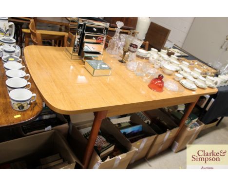 A teak effect extending dining table and six teak ladder back chairs 