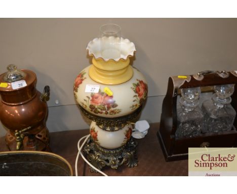 A coloured glass and brass table lamp in the form of an oil lamp