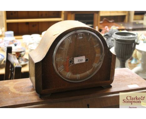 An oak cased two hole mantel clock