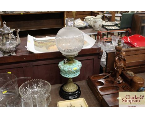 A Victorian table lamp with opaque glass reservoir 