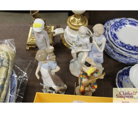 A Lladro figurine of a girl with kittens; a Nao ware figurine; another and a Harlequin figure 