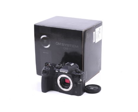 An Olympus OM-1 Digital Mirrorless camera body. With two batteries, instruction manual, two straps and makers box. In excelle
