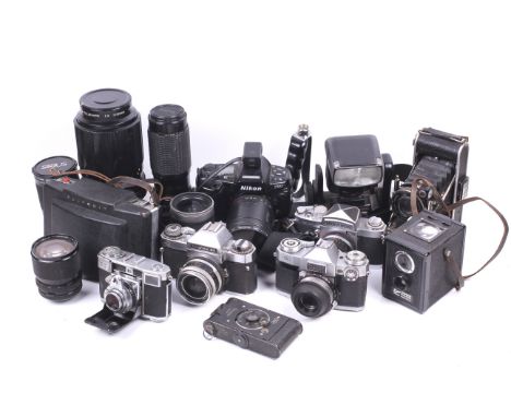 A collection of cameras and lenses. To include a Zeiss Ikon 35mm rangefinder, a Nikon F90, a Zeiss Ikon Icarex 35, a Polaroid