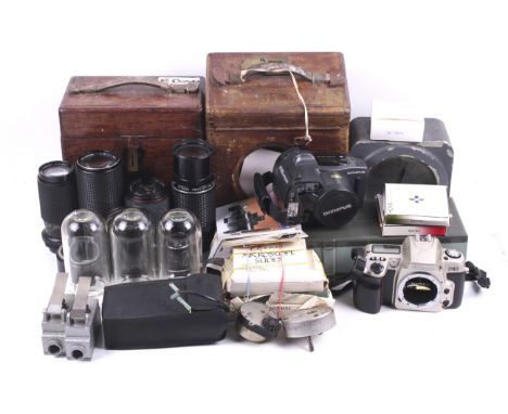 An assortment of cameras and accessories. To include a Nikon F60, an Olympus AZ-300 Superzoom, a Tokina 8-200mm f4 lens, a Ca