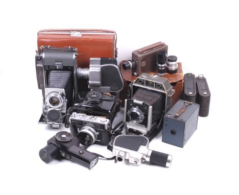 An assortment of cameras and accessories. To include a Polaroid 120 rangefinder, a Tokyo a blue Kodak Brownie, an Olympus 35-