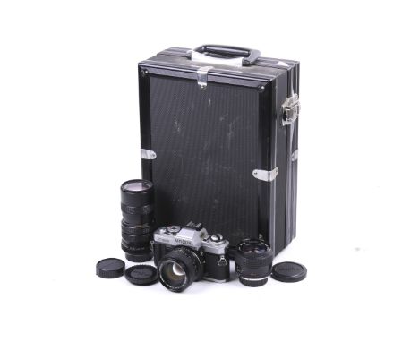 A Minolta X-500 35mm SLR camera outfit. With three lenses; a Minolta 24mm f2.8 MC W.Rokkor SI, a Minolta 50mm f1.4 MC Rokkor 