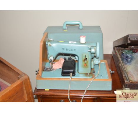 A Singer electric sewing machine in fitted case - sold as collector item 