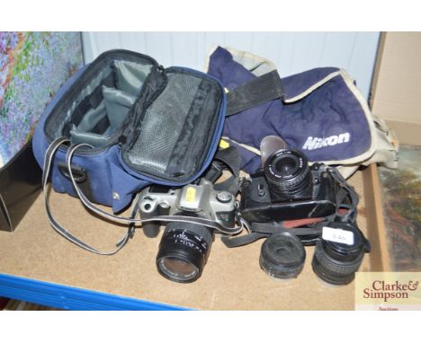 A Cannon camera and a Nikon camera with carrying bags