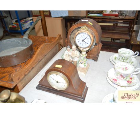 An oak cased two hole mantel clock; a chequer banded inlaid mantel clock; and one other 
