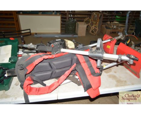 An Ekman petrol multi tool with rotovator, strimmer, chain saw, and hedge trimmer attachments 