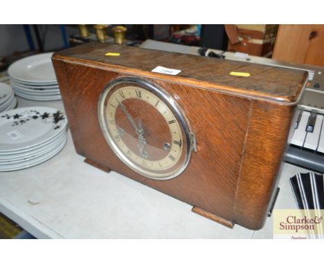 An oak cased three hole Art Deco mantel clock 