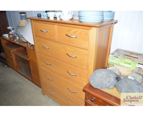 A light oak chest fitted two short over four long drawers