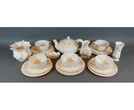 A collection of Belleek to include a teapot, cups and saucers and three vases 