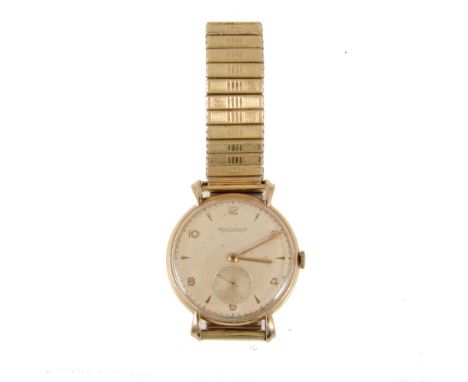 Jaeger le Coultre - a gentleman's yellow metal wrist watch, circular light champagne baton dial with even number Arabics and 