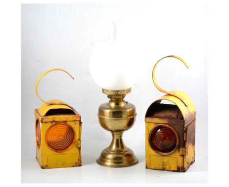 Three yellow enamelled Chalwyn road lamps and a brass oil lamp (4).