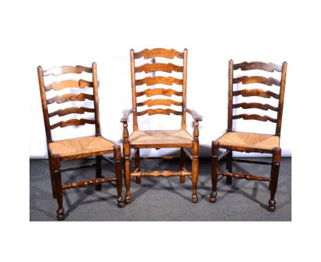 Harlequin set of six ash, elm and beechwood wavy ladder-back dining chairs, with rush seats, turned legs, including a pair of