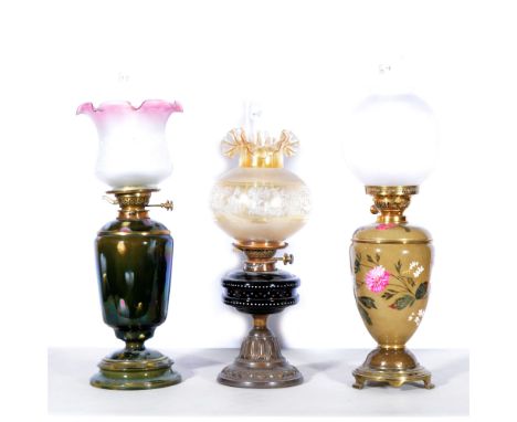 Three oil lamps, to include Hink's Duplex, orange shade with impressed floral design, black ceramic reservoir with patterned 