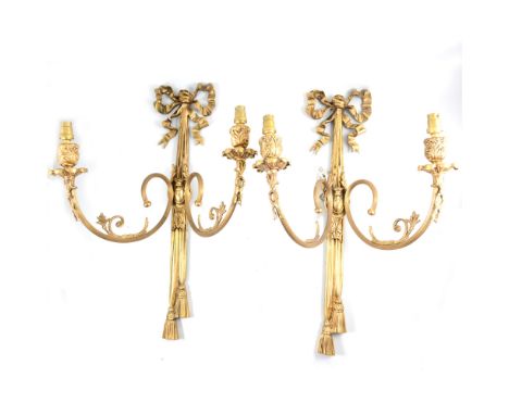 Set of four French Empire inspired gilt metal two-light wall sconces, reeded branches with ribbon ties, 56cm., (some damage).