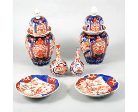 Pair of Imari covered vases, slightly fluted form, panelled decoration, flowers and foliage, 22cm, two small Imari bottle vas