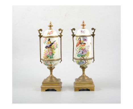 Pair of French gilt metal and painted enamel garniture urns, decorated with garden birds amongst blossom, 29cm.