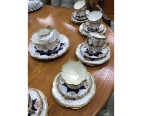 FLORAL AND GILT TEA SERVICE, comprising 12 trops, milk, sugar and a side plate