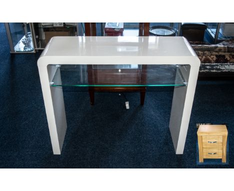 A Contemporary White High Gloss and Glass Console Table. 30 inches in height and 35 inches wide. A Contemporary Oak Bedside T