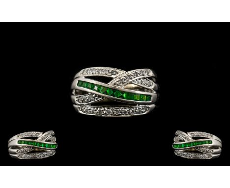 14ct White Gold - Attractive Contemporary Design Emerald and Diamond Dress. Marked 14ct, The Step cut Emerald of Excellent Co