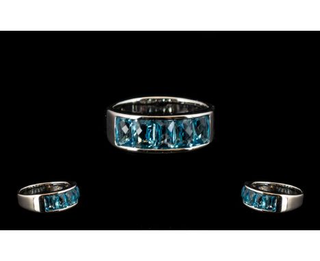 Swiss Blue Topaz Band Ring, five octagon cut Swiss blue topaz, totalling 3.75cts, channel set in rhodium vermeil and silver; 