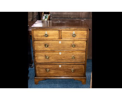 A Mahogany Chest of Drawers reconstructed from old parts with graduated drawers. With brass drop handles terminating on brack