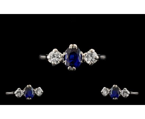 Platinum Set Nice Quality 3 Stone Diamond and Sapphire Ring of pleasing form, circa 1950's. The central natural sapphire flan