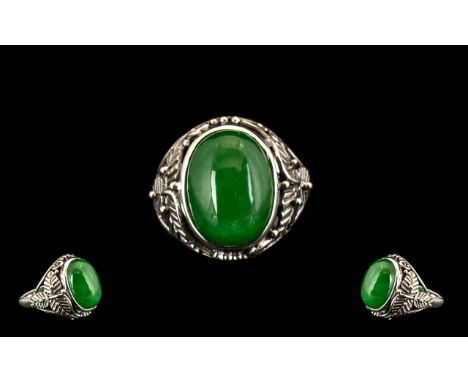 Green Jade Solitaire Ring, an 11.25ct cabochon cut solitaire green jade, bezel set in a hand crafted silver mount with three 