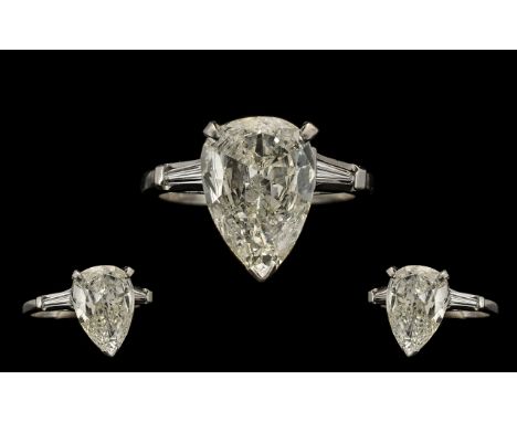 A Fine Quality Platinum and Iridium 8 Single Stone Diamond Set Dress Ring - the large pear shaped faceted diamond estimated t