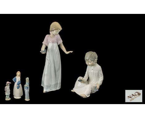 A Collection of Porcelain Figures 1. Nao girl in a nightdress carrying a candle stick 11 inches in height 2. A boy sitting do