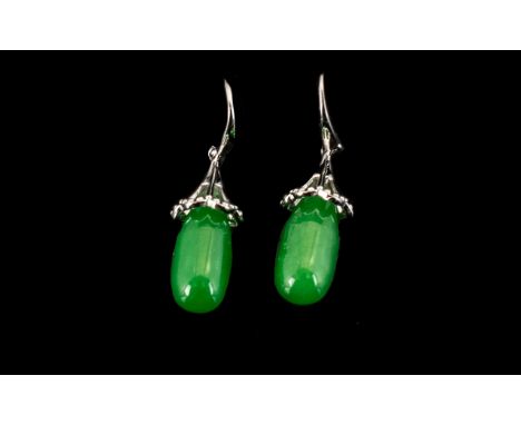 Green Jade Pendant Earrings, 15cts; elongated pear drops of green jade, each of 7.5cts, with openwork 'lantern' caps, suspend