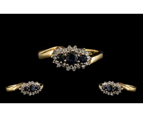 Ladies 9ct Gold Attractive Diamond &amp; Sapphire Set Dress Ring.  The three central sapphires surrounded by 18 small diamond