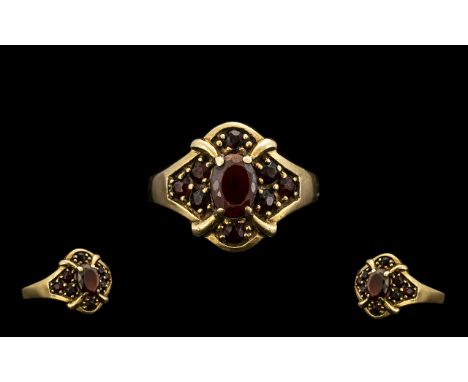 9ct Gold Attractive Garnet Set Cluster Ring flowerhead design, full hallmark for 9.375.  Ring size P.  4.3 grams