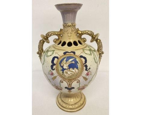 A ceramic two handled urn style Tuscan Ware vase with nesting bird, ribbon and floral decoration. Name stamp and registered n