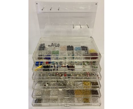 A jewellery makers Perspex chest of drawers and hanging hooks back panel. Containing a large quantity of jewellery making fix