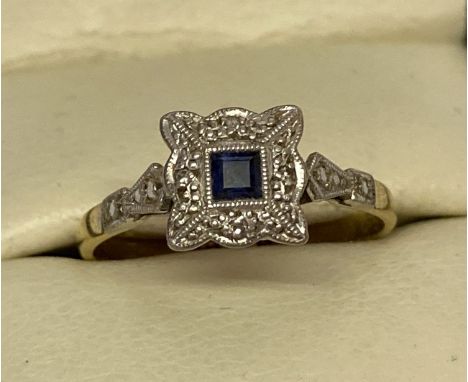 An Art Deco 18ct gold and platinum, sapphire and diamond dress ring. Square shaped mount with fluted edges. Central set squar