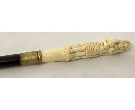 A bone topped walking cane with screw in finial in the form of a woman.  Approx. 93cm long.