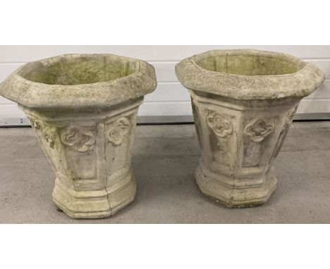 A pair of large octagonal shaped stone planters with quatrefoil panel detail.  Approx. 53cm tall x 53cm diameter.