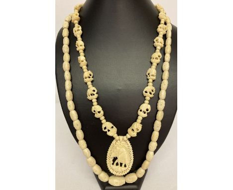 2 vintage carved bone necklaces. A graduating bead necklace with circle decoration together with a drop carved pendant neckla