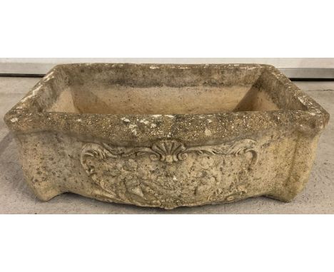 A stone trough style garden planter with carved cherubs and floral detail to front. Drainage hole to base. Approx 20 x 54 x 3