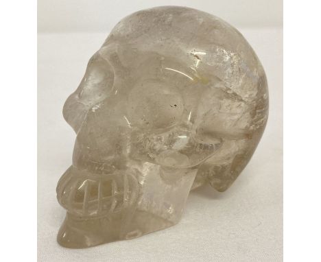 A small carved rock crystal figurine in the shape of a skull.  Approx. 6cm x 7.5cm.