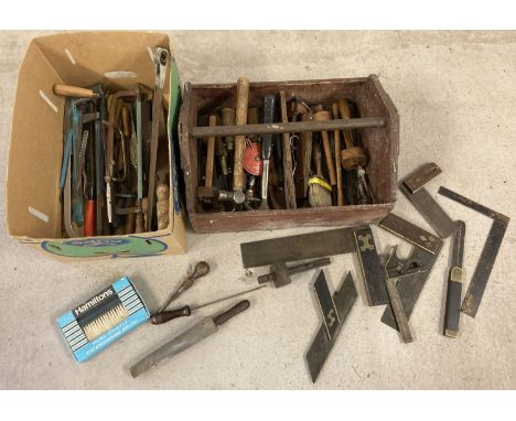 A wooden tool crate with carry handle containing an assortment of mostly carpenters tools. To include: squares mortice and ma
