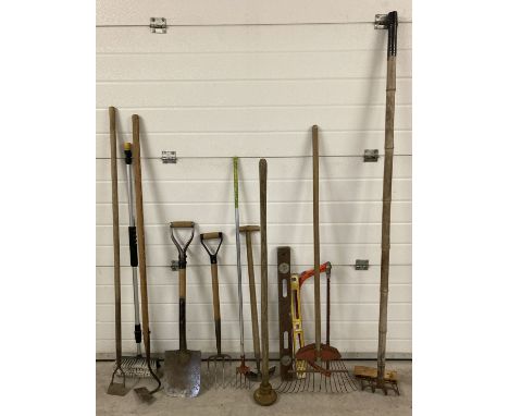 A collection of vintage and modern gardening tools. To include: post hole rammer, rakes, spade, fork and hoe. 