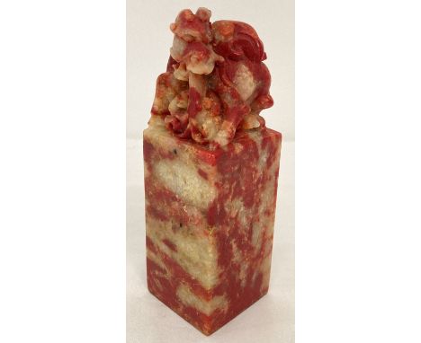 A large Chinese red soapstone seal with carved dragon shaped finial.  Approx. 15.5cm tall.