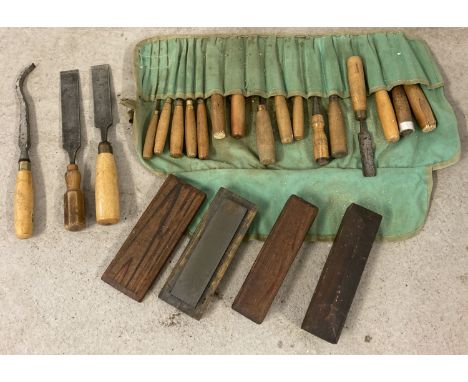 A collection of 16 vintage varying sized chisels in a cloth roll. Together with 2 larger chisels, a goose neck chisel and 3 s