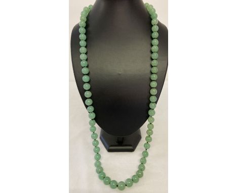 A 32" Chinese jade beaded necklace, knotted between each bead.  Bead size approx. 1cm diameter.