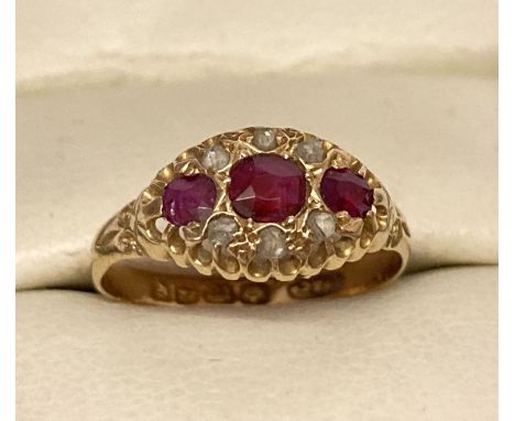 An Edwardian style 18ct gold, ruby and diamond dress ring. 3 central rubies with 3 small diamonds set either side. Full hallm